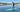 female paddleboarder on Sandbanks Style paddleboard dressed for winter paddling